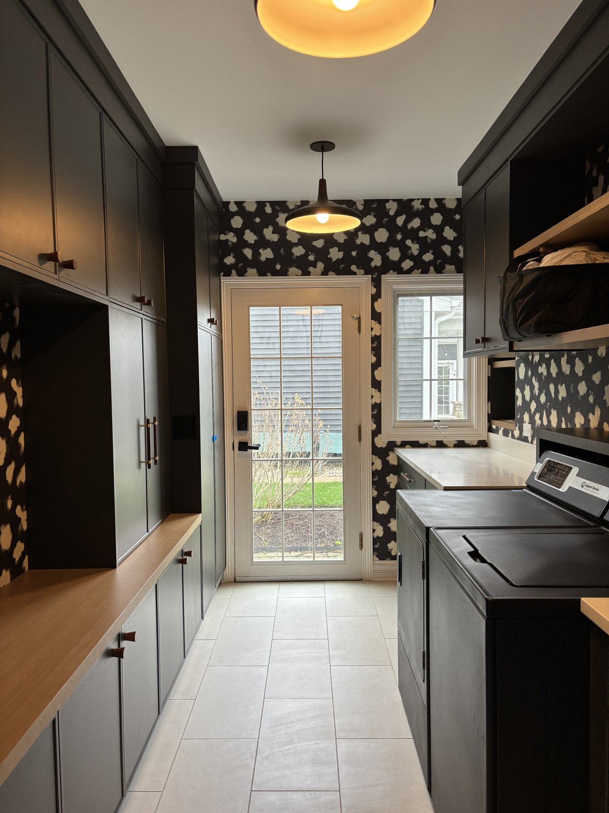After: custom charcoal mudroom with bench cubbies and statement wallpaper by Boxhouzz