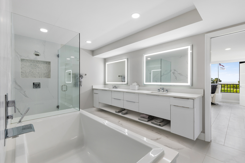 Sarasota modern bath with floating double vanity and lit mirrors