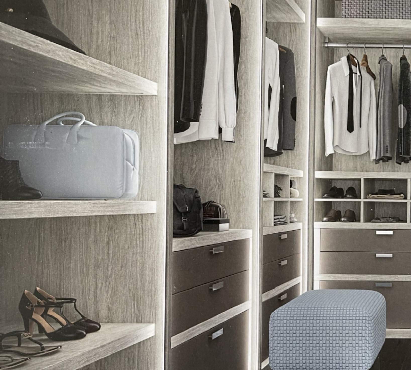 Gray woodgrain walk-in closet with lit shelving, drawer banks and shoe display