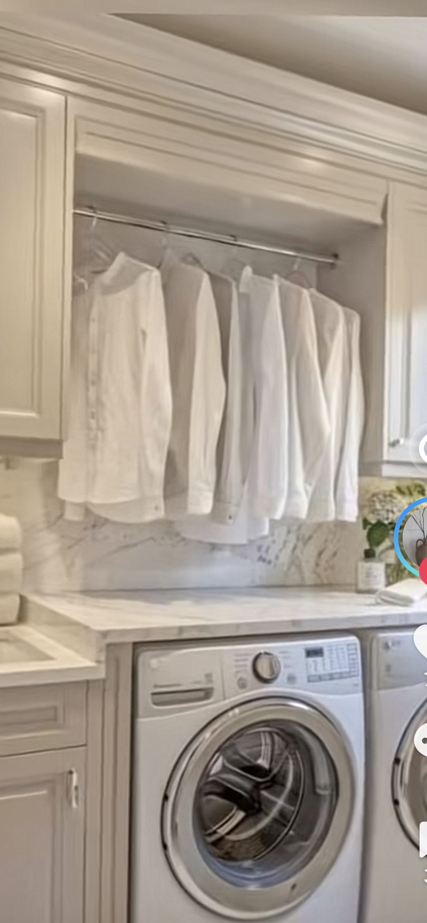 Traditional white laundry room with marble backsplash and hanging rod