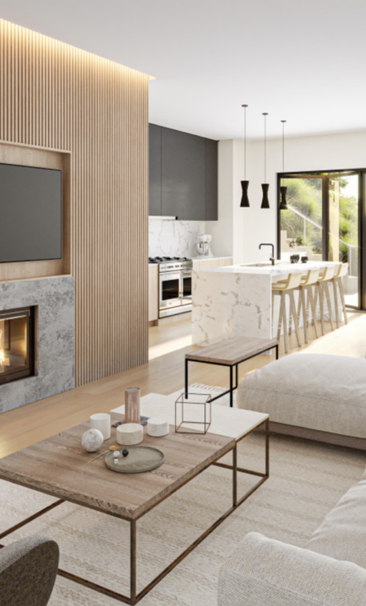 Fluted oak fireplace wall with TV niche opening to a dark cabinetry kitchen and marble island