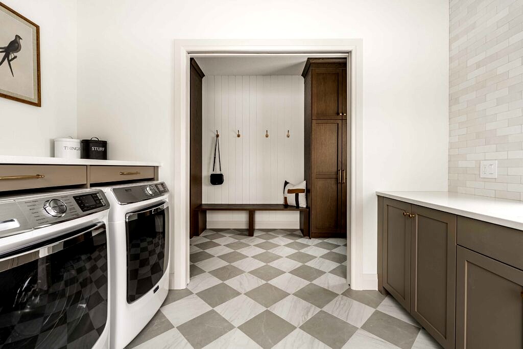 Mudroom with dark wood lockers, bench and checkerboard marble floor